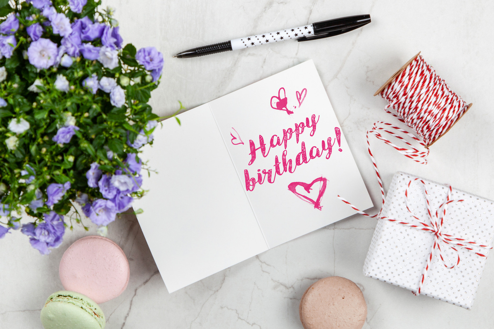 Happy Birthday postcard on white marble table